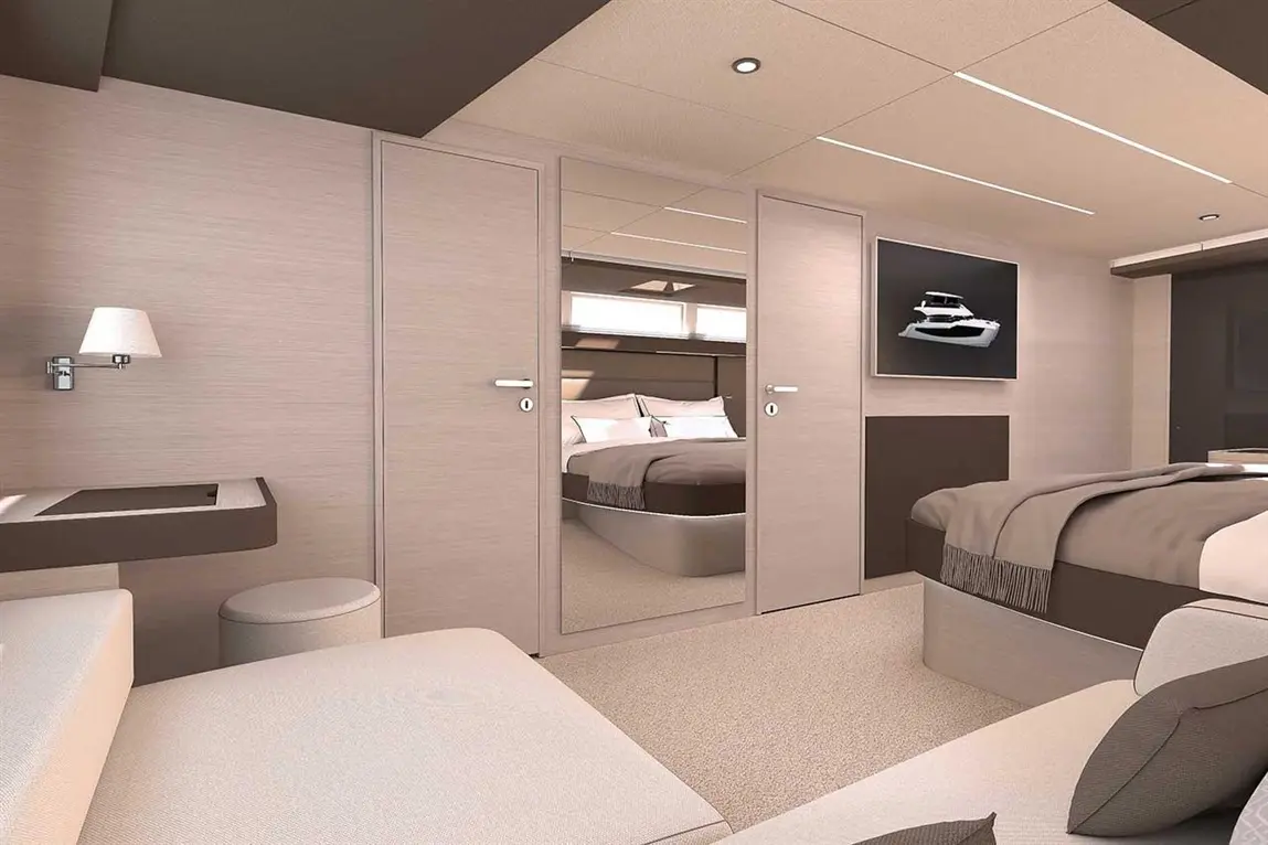 Modern yacht interior featuring a spacious cabin, double bed, wall-mounted TV, and stylish lighting fixtures.